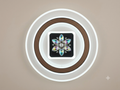 A modern ceiling light unit that combines simple circular light rings with a central design adorned with iridescent crystals forming a sparkling geometric star or flower.