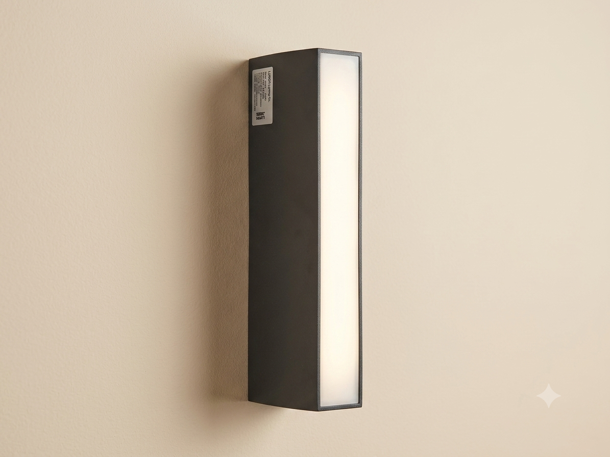 A linear wall sconce with a modern black rectangular design and an extended white light front.