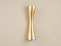A wall light fixture with a streamlined metal design that mimics the shape of an hourglass with an elegant, matte gold finish, designed to distribute light smoothly up and down.
