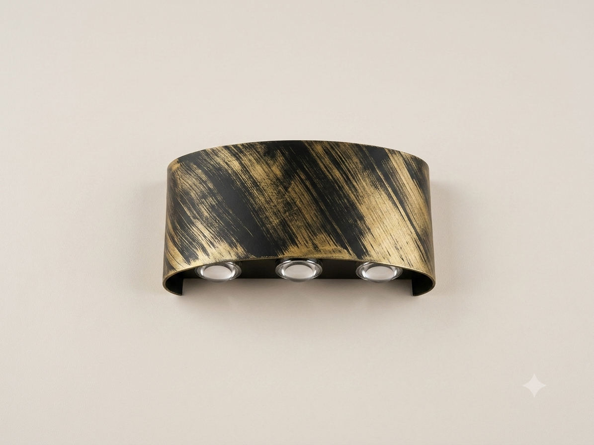 A gold wall sconce with an elegant curved metal design featuring three spherical bulbs that distribute light upwards.