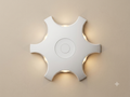 A white wall sconce with a modern design in the shape of a six-pointed star that distributes light from its side recesses.