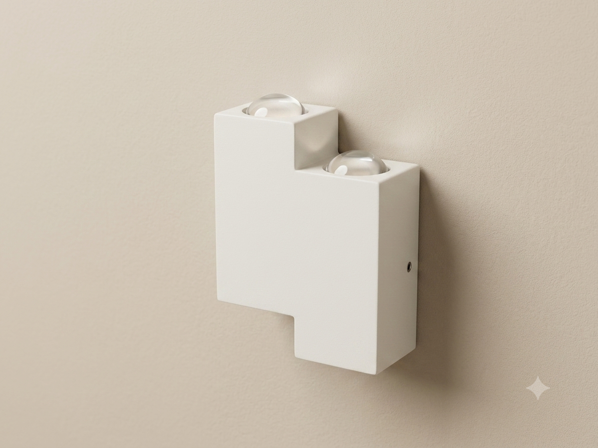 White wall sconce with a stepped cube design and prominent spherical glass lenses.