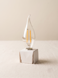 LED filament lamp with a tip-shaped design inspired by a water droplet.