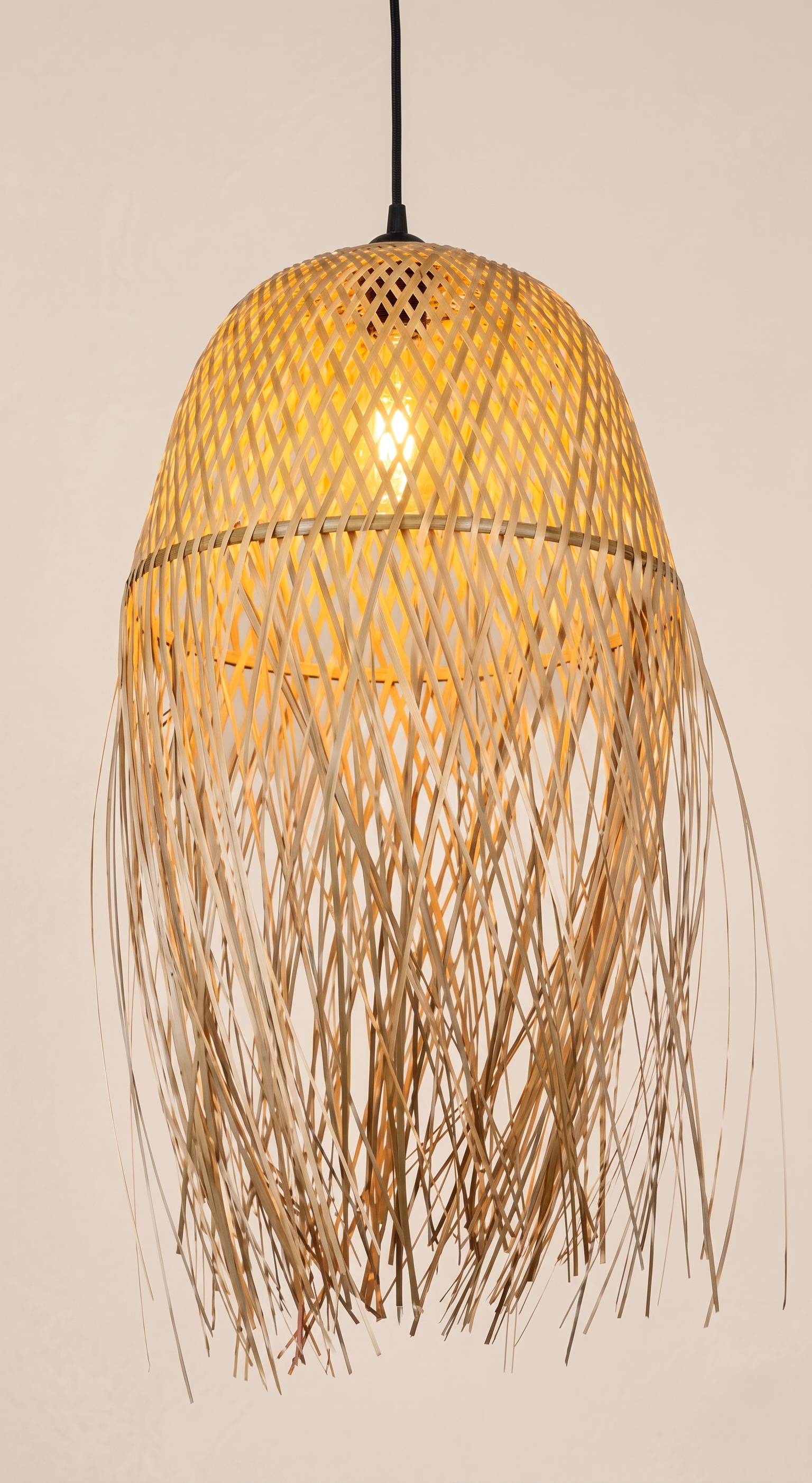 A pendant light unit made from hand-woven bamboo with a streamlined, organic design.