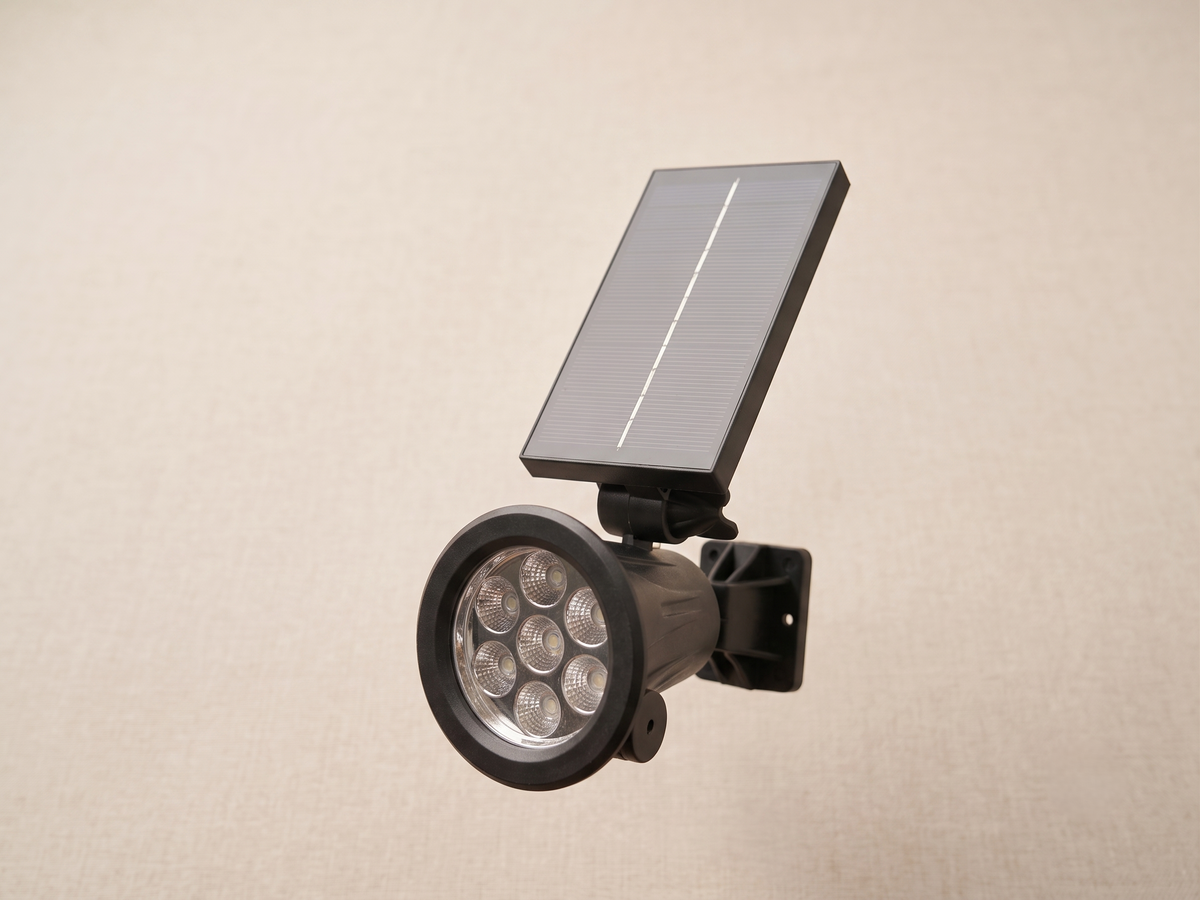 Solar-powered outdoor lighting unit with a top solar panel and multiple LED lights.