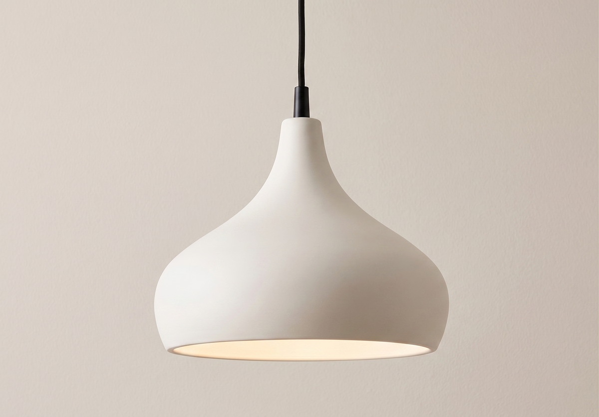 A minimalist pendant light unit inspired by soft organic shapes, featuring a matte white finish that brings a sense of calm and modern elegance to the space.