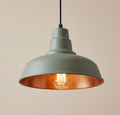 An industrial-style pendant light unit, combining a matte green exterior finish and a warm copper lining to reflect rich and comfortable light.