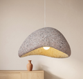 A pendant lamp with a streamlined design resembling natural rock with a pleasing texture.