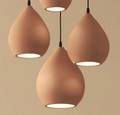 A collection of pendant lamps that combines the simplicity of contemporary design with the warm color of natural pottery, forming a flowing light cluster that enriches interior spaces.