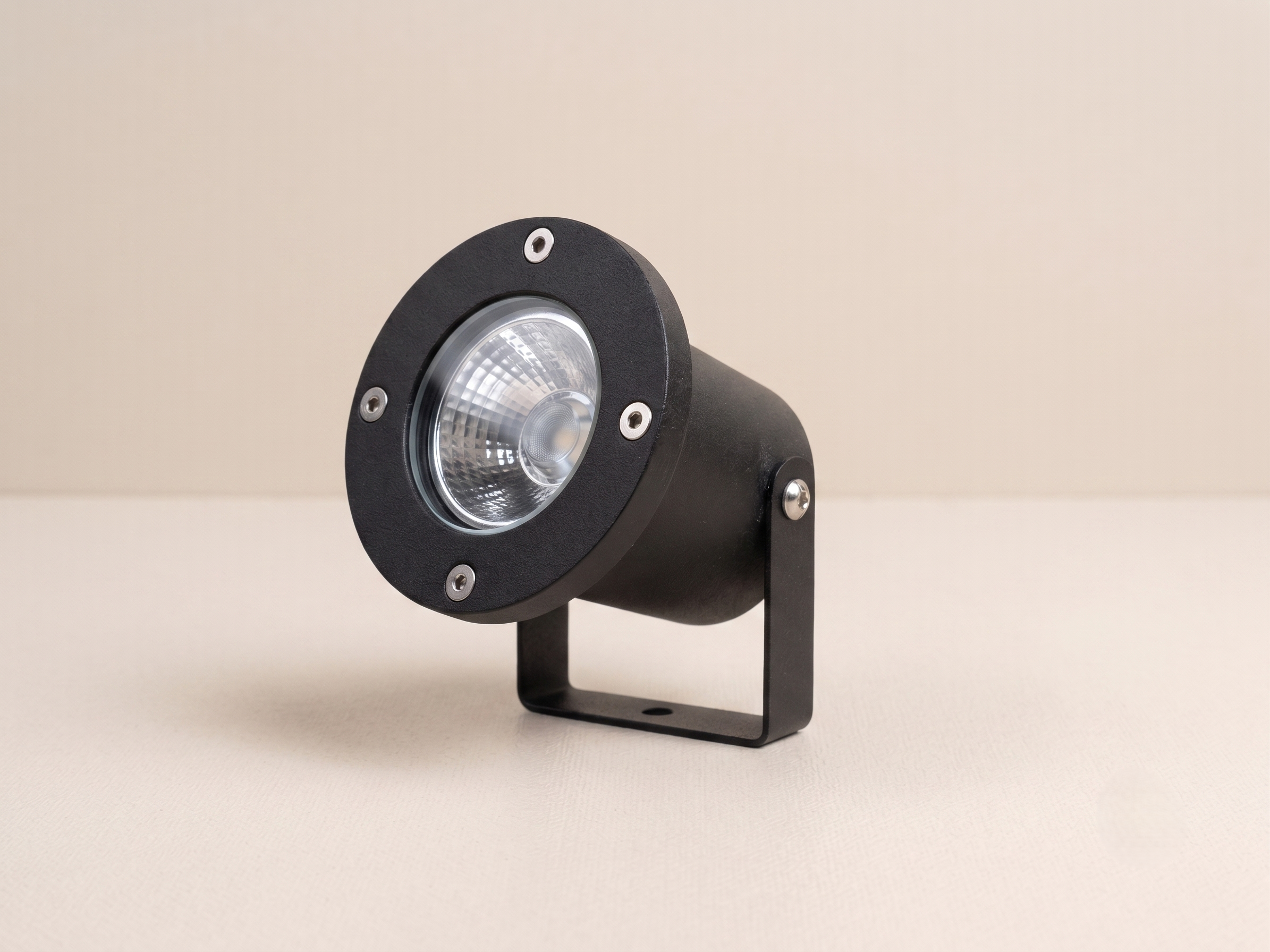 Outdoor spotlight unit with adjustable mounting hardware and black metal housing.