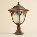Ornate pedestal lantern with leaf motifs and hammered glass