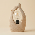 Sculptural sandstone arch table lamp with exposed spiral bulb